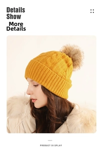 Detailed knit pattern of a yellow winter beanie with a fluffy faux fur pom-pom topper