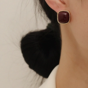 Elegant vintage square dark red earrings with gold trim worn for a chic look