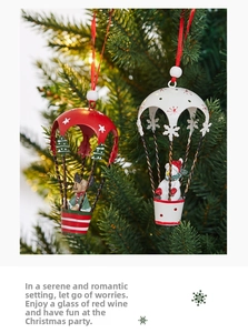 Close-up of hanging Christmas hot air balloons with Santa and reindeer on a tree