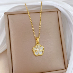 Elegant gold titanium necklace featuring a five-petal flower pendant with white shell inlay
