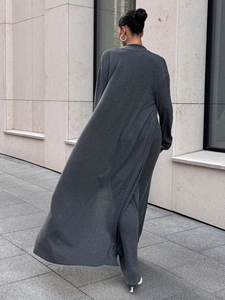 Detail of grey knitted long cardigan showing soft texture and elegant ankle-length drape