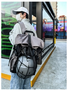 Detail of grey functional backpack with helmet mesh net and ripstop texture for sports