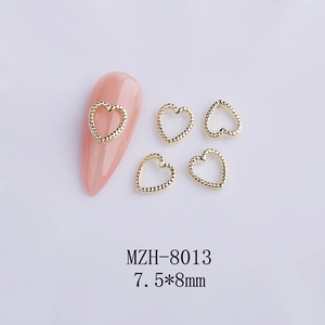 Detail of hollow heart metal nail art charms, size 7.5x8mm, gold finish for manicure