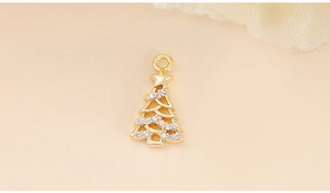 Detailed view of a gold Christmas tree pendant with cubic zirconia and hanging loop