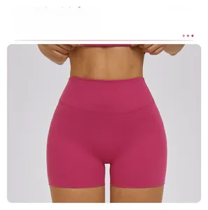 Detail view of high waist yoga shorts in magenta, seamless ribbed fabric for fitness