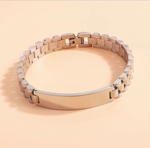 Close-up of silver stainless steel link bracelet with engravable blank nameplate