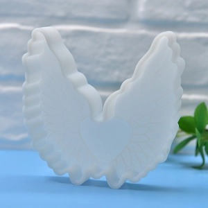 White silicone mold for angel wing and heart shaped DIY candles or soaps