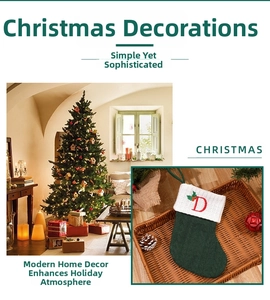 Detail of green knitted Christmas stocking featuring red embroidered letter D and white cuff