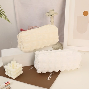 Large cream puff pencil case with bubble texture shown in a lifestyle display