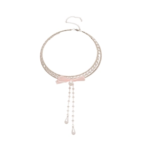 Three-layer pearl choker with pink bow and teardrop charms on a clean white background