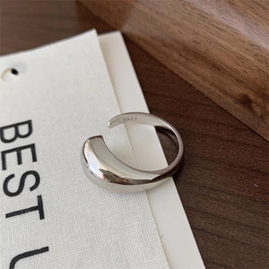 Detailed close-up of a silver water drop ring showing the S925 hallmark on polished metal