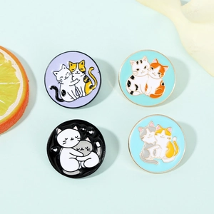 Detail of four colorful enamel cat hug pins with gold-tone circular metal frames