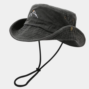 Detail of dark grey sun hat featuring mountain embroidery, air vents and adjustable chin cord