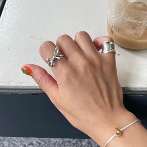 925 sterling silver bow ring and snake chain bracelet with golden J pendant on model