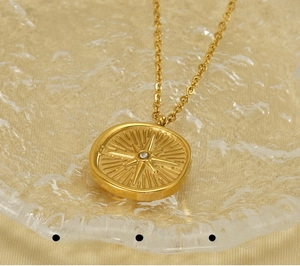 Detail of 18k gold starburst necklace featuring eco-friendly plating and polished finish