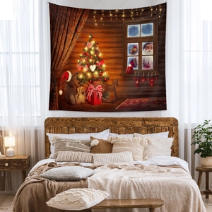 Detail of Christmas tapestry featuring a glowing tree and Santa Claus in a cozy bedroom