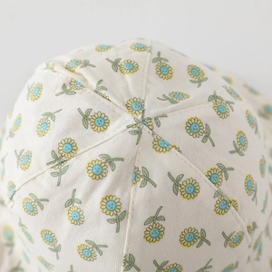 Detailed top view of a baby sun hat featuring yellow sunflower prints and quality stitching