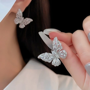 Close-up of elegant silver butterfly stud earrings with sparkling cubic zirconia inlay