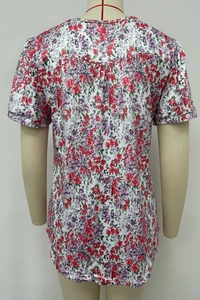 Detailed back view of floral short sleeve top featuring shirring and colorful flower prints