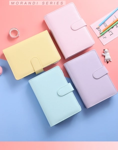 Flat lay of macaron PU leather A6 binders in pink yellow blue and purple tones