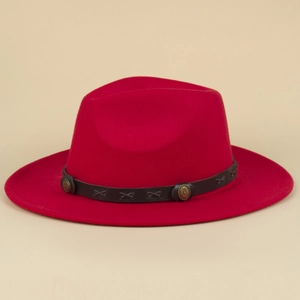 Detail of red fedora hat featuring a brown leather belt with bronze studs and X-stitching