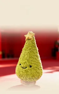 Close-up of green plush Christmas tree toy with golden star and embroidered smiling face