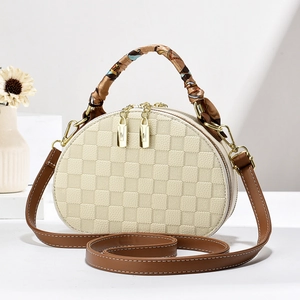 Detail of checkered mini bag with silk scarf handle and golden double zippers