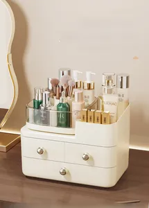 Detail of multi-layered cream makeup organizer with gold handles and rotating top