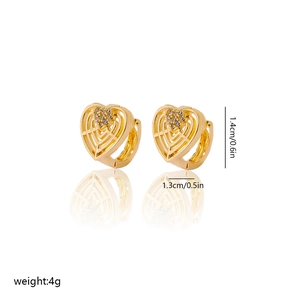 Detailed view of heart-shaped gold-plated copper earrings with cubic zirconia inlay