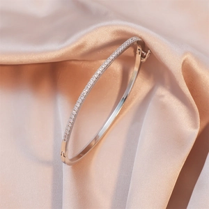 Classic silver-plated open bangle with micro-set zircons on elegant silk background