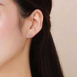 S925 sterling silver heart stud earrings with sparkling cubic zirconia on model