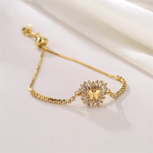 Detail of gold butterfly heart bracelet with zircons and adjustable sliding clasp