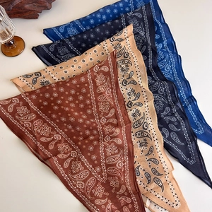 Close-up of vintage paisley print scarf necklaces in various colors with fabric detail