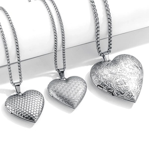 Three vintage stainless steel heart locket necklaces with various embossed textures