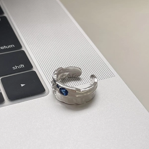Irregular textured S925 silver ring with blue and white zircon stones on laptop