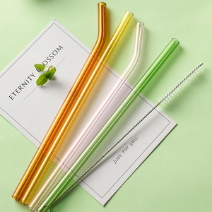 Set of four colorful heat-resistant borosilicate glass straws with cleaning brush