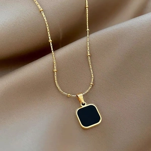 Chic gold titanium steel necklace with black square pendant on champagne silk background