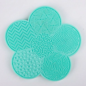 Detail of mint green flower silicone brush cleaner with various scrubbing textures