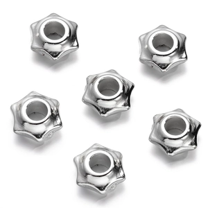 Macro view of six silver star-shaped large hole spacer beads for DIY jewelry making