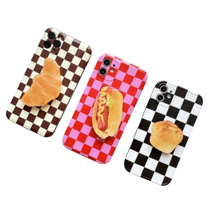 3D realistic bread and hot dog food models on checkered pattern phone socket stands