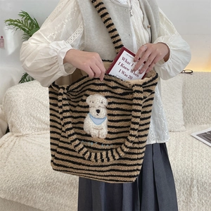 Detail of plush striped dog tote bag showing large capacity and soft faux fur texture