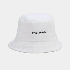 Close-up of black mama embroidery on a white terry cloth bucket hat fabric