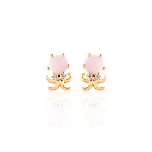 Macro shot of creative pink octopus earrings with golden metal and sparkling cubic zirconia
