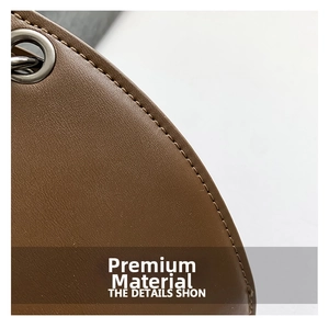 Close-up of brown textured leather stitching and silver eyelet on bat-shaped jelly bag