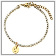 Detail view of 18K gold bead chain anklet with crystal pendant and letter C charm