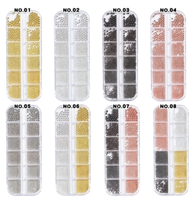 Close-up of assorted gold, silver, and rose gold nail art caviar beads in plastic boxes