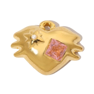 Detail of heart pendant with pink gemstone and pearl inlay on irregular golden metal