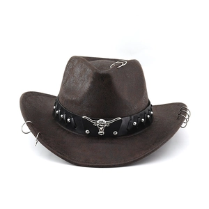 Close-up of brown faux leather cowboy hat with silver bull head emblem and metal studs