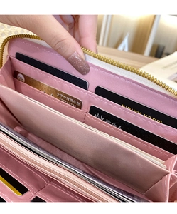 Interior view of pink long purse featuring multiple card slots and zip coin pocket