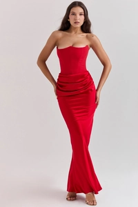 Detail of red satin evening gown featuring corseted bodice and elegant draped pleats